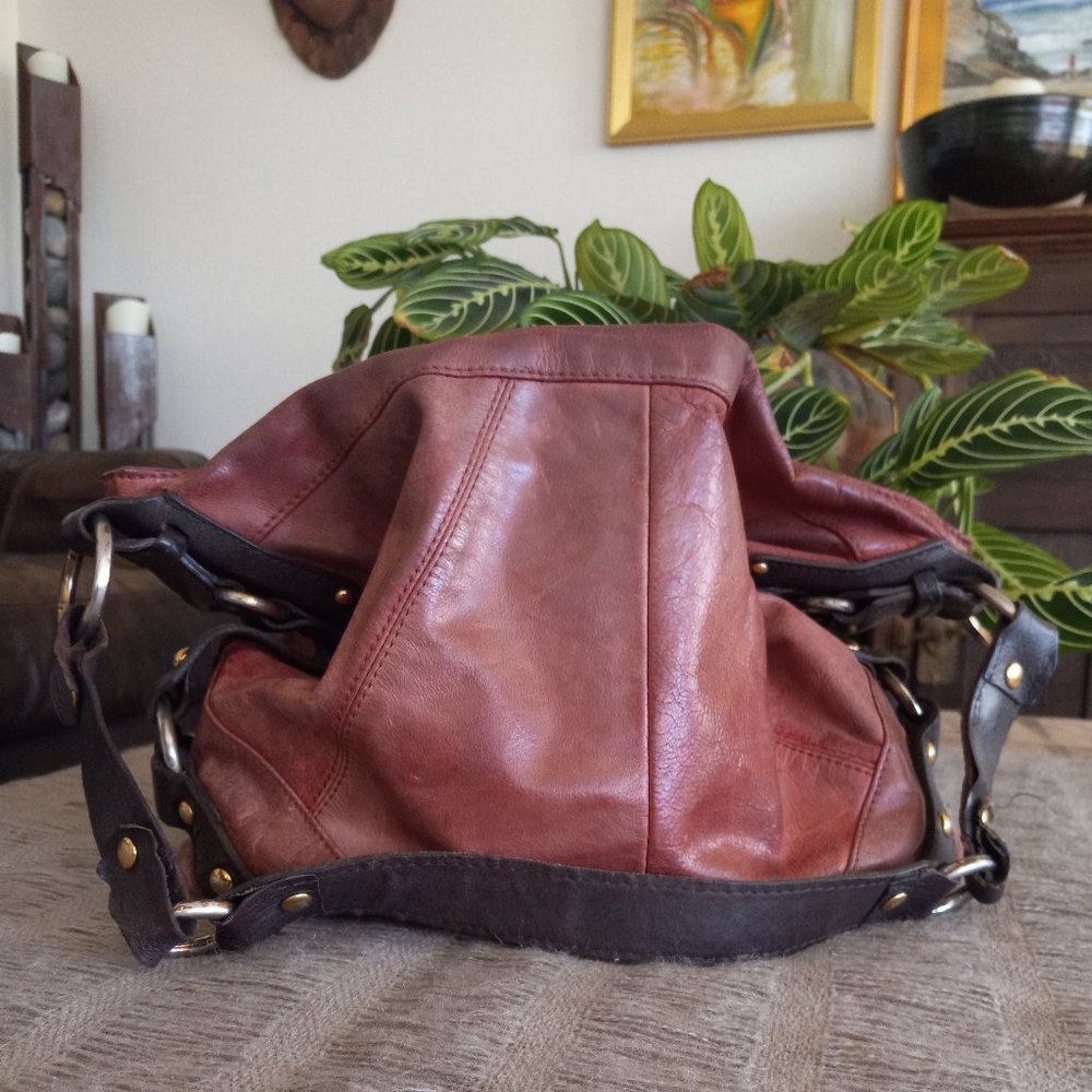 Large red and brown leather hobo bag with metal accents - Tashe